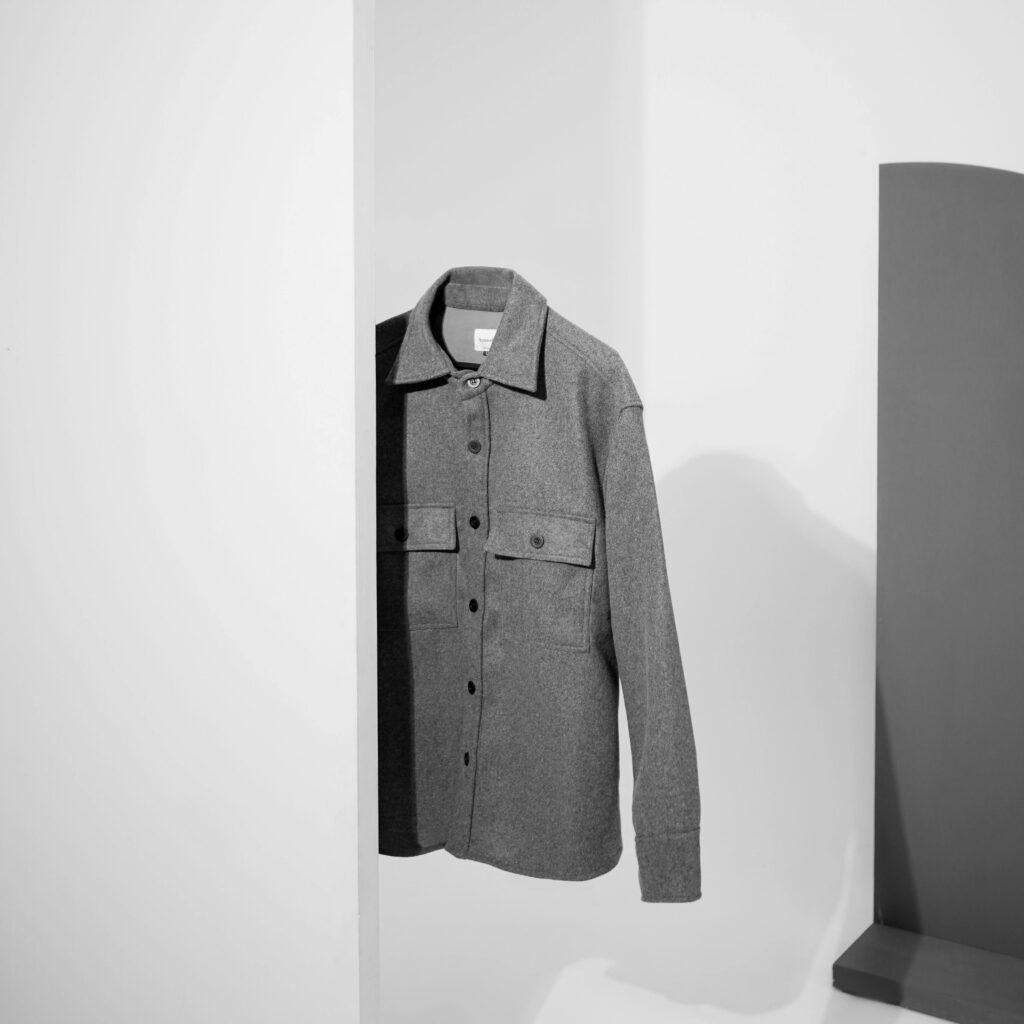 Minimalist display of a gray shirt in black and white with ample copy space.